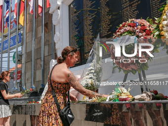 Tourists lay flowers at the Bali Bombing Memorial during the 22nd commemoration of the 2002 Bali bombing tragedy in Kuta, Bali, Indonesia, o...