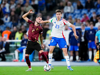 Zeno Debast of Belgium and Niccolo' Pisilli of Italy compete for the ball during the UEFA Nations League 2024/25 League A Group A2 match bet...