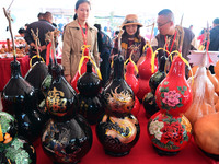 Visitors buy craft gourds at the Gourd Culture and Art Festival in Liaocheng, China, on October 12, 2024. (