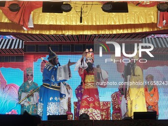 Chinese opera performers are on stage during the Vegetarian Festival at a Chinese shrine in Bangkok, Thailand, on October 7, 2024. The Veget...