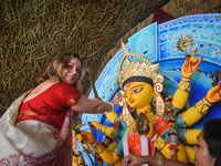 A foreigner performs rituals to an idol of the Hindu goddess Durga while offering prayers on the last day of the Durga Puja festival in Kolk...