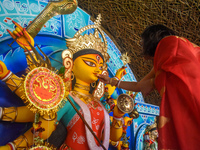 A woman offers sweets to an idol of the Hindu goddess Durga while offering prayers on the last day of the Durga Puja festival in Kolkata, In...