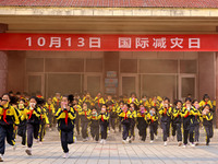 Primary school students perform an emergency escape drill in Zaozhuang, China, on October 12, 2024. (