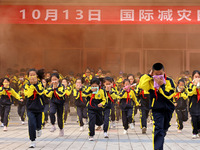 Primary school students perform an emergency escape drill in Zaozhuang, China, on October 12, 2024. (