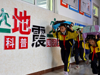 Primary school students conduct a fire emergency escape drill in Zaozhuang, China, on October 12, 2024. (