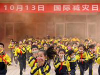 Primary school students perform an emergency escape drill in Zaozhuang, China, on October 12, 2024. (