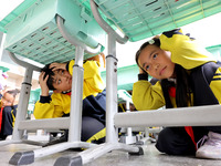 Primary school students participate in an earthquake preparedness and disaster reduction drill in Zaozhuang, China, on October 12, 2024. (