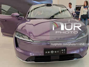 A new energy vehicle is displayed at the Huawei Global flagship store on Nanjing Road Pedestrian Street in Shanghai, China, on October 12, 2...