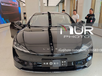 A new energy vehicle is displayed at the Huawei Global flagship store on Nanjing Road Pedestrian Street in Shanghai, China, on October 12, 2...