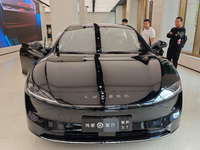 A new energy vehicle is displayed at the Huawei Global flagship store on Nanjing Road Pedestrian Street in Shanghai, China, on October 12, 2...