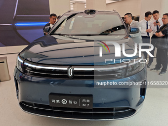 A new energy vehicle is displayed at the Huawei Global flagship store on Nanjing Road Pedestrian Street in Shanghai, China, on October 12, 2...