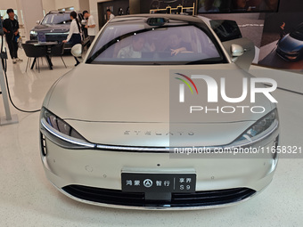 A new energy vehicle is displayed at the Huawei Global flagship store on Nanjing Road Pedestrian Street in Shanghai, China, on October 12, 2...