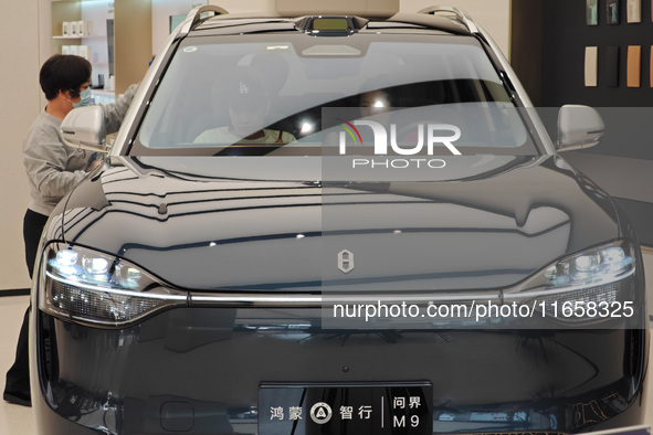 A new energy vehicle is displayed at the Huawei Global flagship store on Nanjing Road Pedestrian Street in Shanghai, China, on October 12, 2...