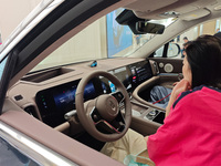 A customer experiences a new energy vehicle at Huawei's global flagship store on Nanjing Road pedestrian Street in Shanghai, China, on Octob...