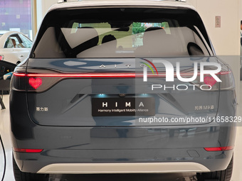 A new energy vehicle is displayed at the Huawei Global flagship store on Nanjing Road Pedestrian Street in Shanghai, China, on October 12, 2...