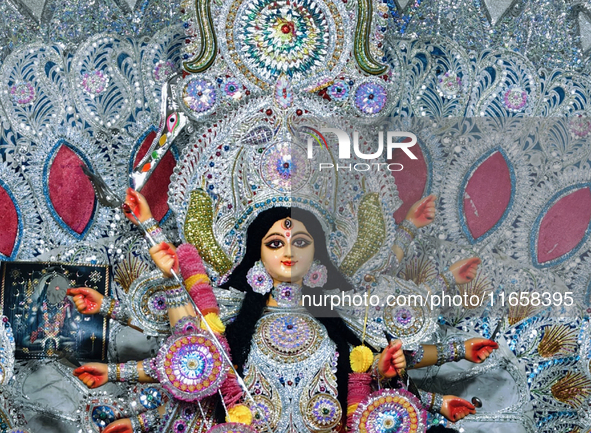 An idol of the Hindu goddess 'Durga' is pictured as devotees arrive to see it during the Durga Puja festival in Siliguri, India, on October...