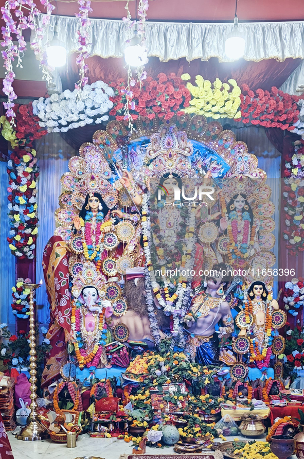 An idol of the Hindu goddess 'Durga' is pictured as devotees arrive to see it during the Durga Puja festival in Siliguri, India, on October...