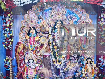 An idol of the Hindu goddess 'Durga' is pictured as devotees arrive to see it during the Durga Puja festival in Siliguri, India, on October...