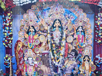 An idol of the Hindu goddess 'Durga' is pictured as devotees arrive to see it during the Durga Puja festival in Siliguri, India, on October...