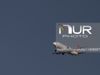 An Iranian airliner flies over the sky in southern Tehran, Iran, on October 11, 2023. (