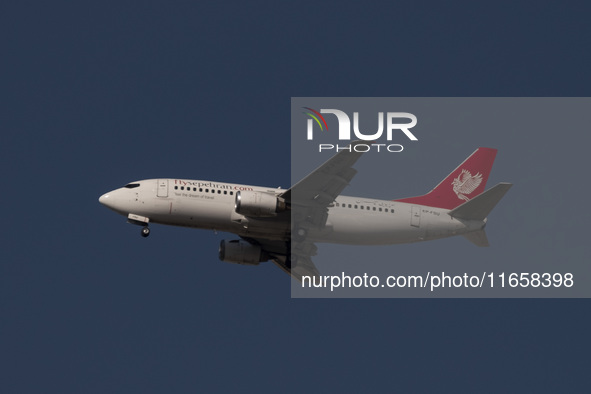 An Iranian airliner flies over the sky in southern Tehran, Iran, on October 11, 2023. 