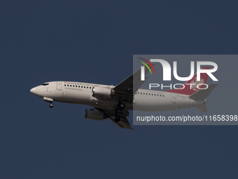 An Iranian airliner flies over the sky in southern Tehran, Iran, on October 11, 2023. (