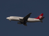 An Iranian airliner flies over the sky in southern Tehran, Iran, on October 11, 2023. (