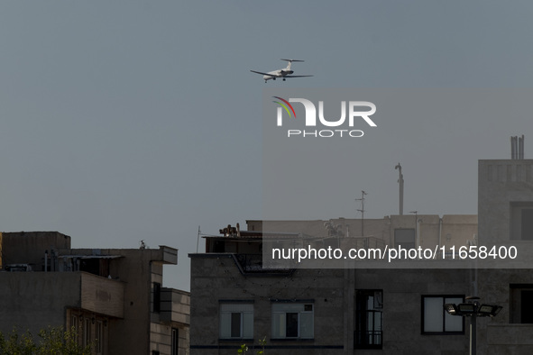 An Iranian airliner flies over a residential area in southern Tehran, Iran, on October 11, 2023. 