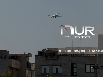 An Iranian airliner flies over a residential area in southern Tehran, Iran, on October 11, 2023. (