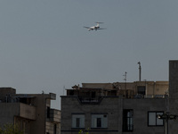 An Iranian airliner flies over a residential area in southern Tehran, Iran, on October 11, 2023. (