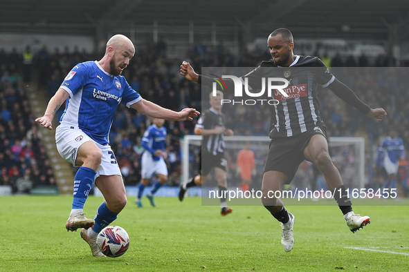 Paddy Madden of Chesterfield is under pressure from Jacob Bedeau of Notts County during the Sky Bet League 2 match between Chesterfield and...