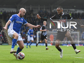 Paddy Madden of Chesterfield is under pressure from Jacob Bedeau of Notts County during the Sky Bet League 2 match between Chesterfield and...