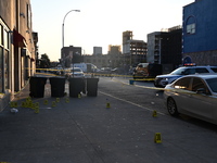 NYPD crime scene investigators place more than 28 evidence markers at the scene where a 27-year-old man is shot multiple times and killed in...