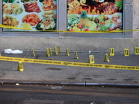 NYPD crime scene investigators place more than 28 evidence markers at the scene where a 27-year-old man is shot multiple times and killed in...