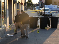 NYPD crime scene investigators place more than 28 evidence markers at the scene where a 27-year-old man is shot multiple times and killed in...