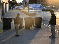 NYPD crime scene investigators place more than 28 evidence markers at the scene where a 27-year-old man is shot multiple times and killed in...