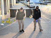 NYPD crime scene investigators place more than 28 evidence markers at the scene where a 27-year-old man is shot multiple times and killed in...