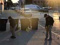 NYPD crime scene investigators place more than 28 evidence markers at the scene where a 27-year-old man is shot multiple times and killed in...