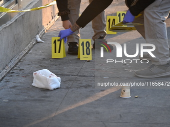 NYPD crime scene investigators place more than 28 evidence markers at the scene where a 27-year-old man is shot multiple times and killed in...