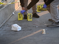 NYPD crime scene investigators place more than 28 evidence markers at the scene where a 27-year-old man is shot multiple times and killed in...