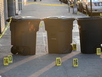 NYPD crime scene investigators place more than 28 evidence markers at the scene where a 27-year-old man is shot multiple times and killed in...