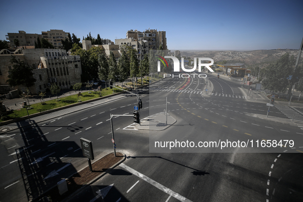 A person walks on a crosswalk on an empty street on Yom Kippur, the Jewish day of atonement and the holiest day in the Jewish calendar, amid...