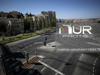 A person walks on a crosswalk on an empty street on Yom Kippur, the Jewish day of atonement and the holiest day in the Jewish calendar, amid...