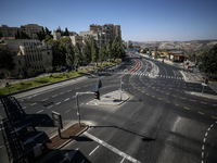 A person walks on a crosswalk on an empty street on Yom Kippur, the Jewish day of atonement and the holiest day in the Jewish calendar, amid...