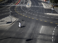 A person walks on a crosswalk on an empty street on Yom Kippur, the Jewish day of atonement and the holiest day in the Jewish calendar, amid...