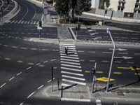 A person walks on a crosswalk on an empty street on Yom Kippur, the Jewish day of atonement and the holiest day in the Jewish calendar, amid...