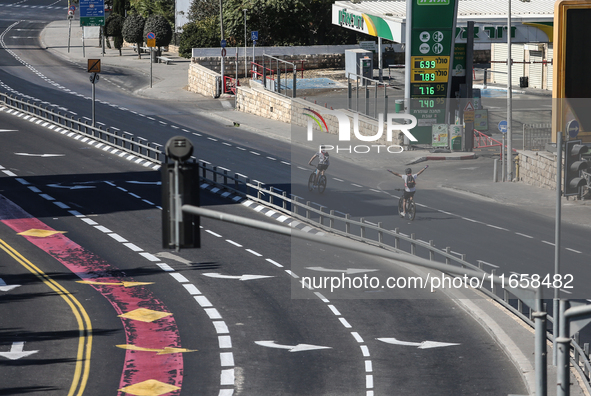 A person walks on a crosswalk on an empty street on Yom Kippur, the Jewish day of atonement and the holiest day in the Jewish calendar, amid...