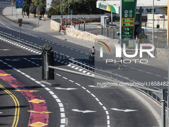 A person walks on a crosswalk on an empty street on Yom Kippur, the Jewish day of atonement and the holiest day in the Jewish calendar, amid...