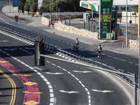 A person walks on a crosswalk on an empty street on Yom Kippur, the Jewish day of atonement and the holiest day in the Jewish calendar, amid...