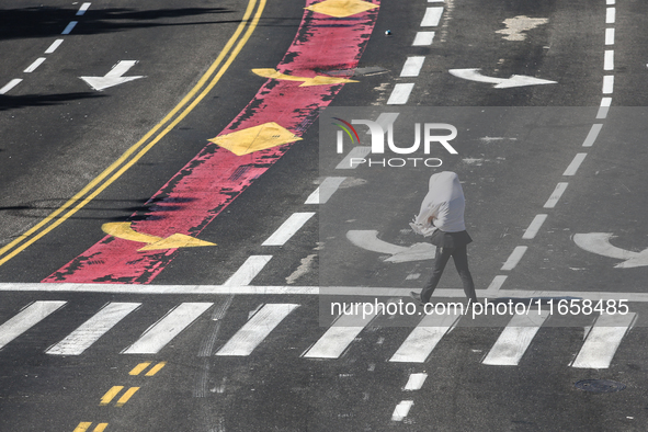 A person walks on a crosswalk on an empty street on Yom Kippur, the Jewish day of atonement and the holiest day in the Jewish calendar, amid...